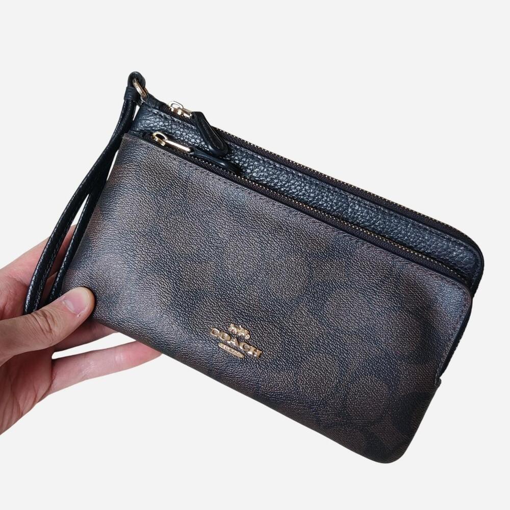 Coach black pebbled leather wristlet with gold hardware